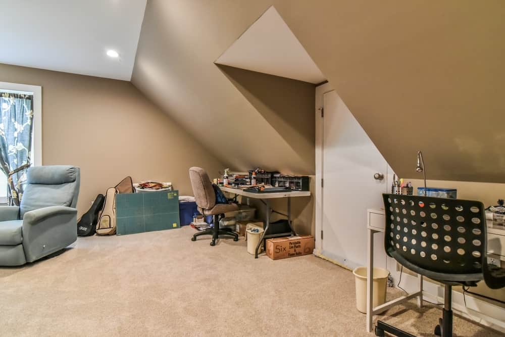 Bonus room under a sloped ceiling used as a hobby and office space