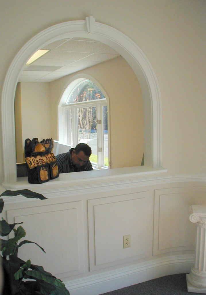 Resinart front office with an arched interior pass-through window