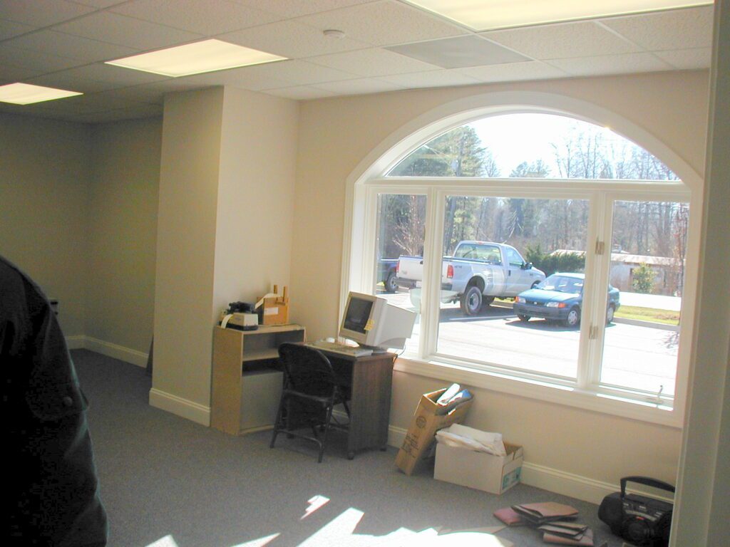 Office with a tall arched window built by Cool Mountain Construction