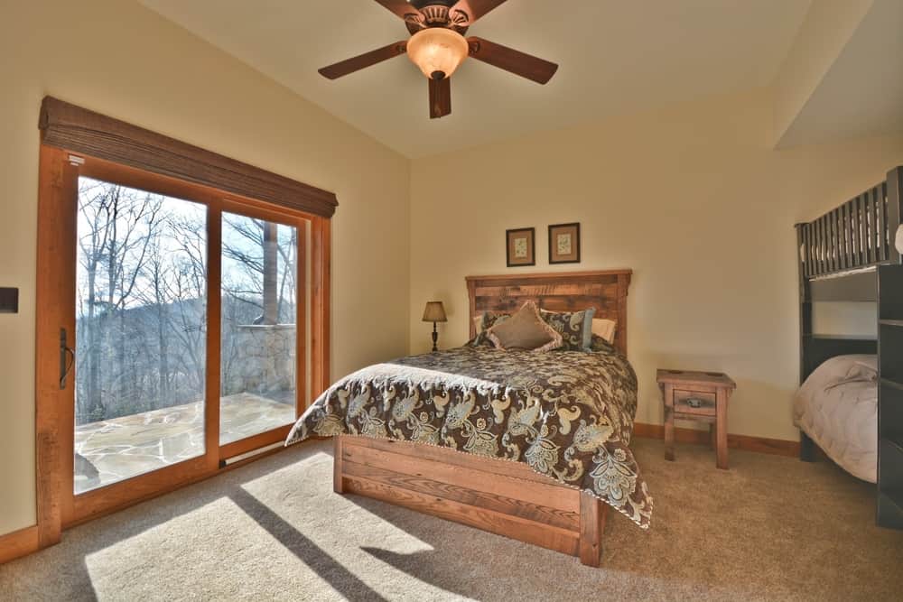 Bedroom with sliding glass doors to a deck, a ceiling fan and a bunk bed