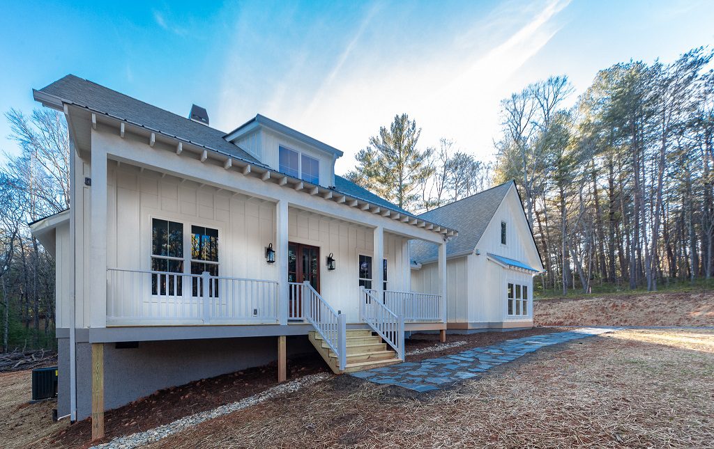 Front elevation with a full-width covered porch and second-story shed dormer