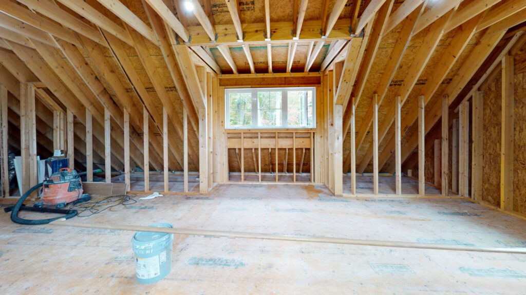 Unfinished bonus room with exposed roof framing during construction
