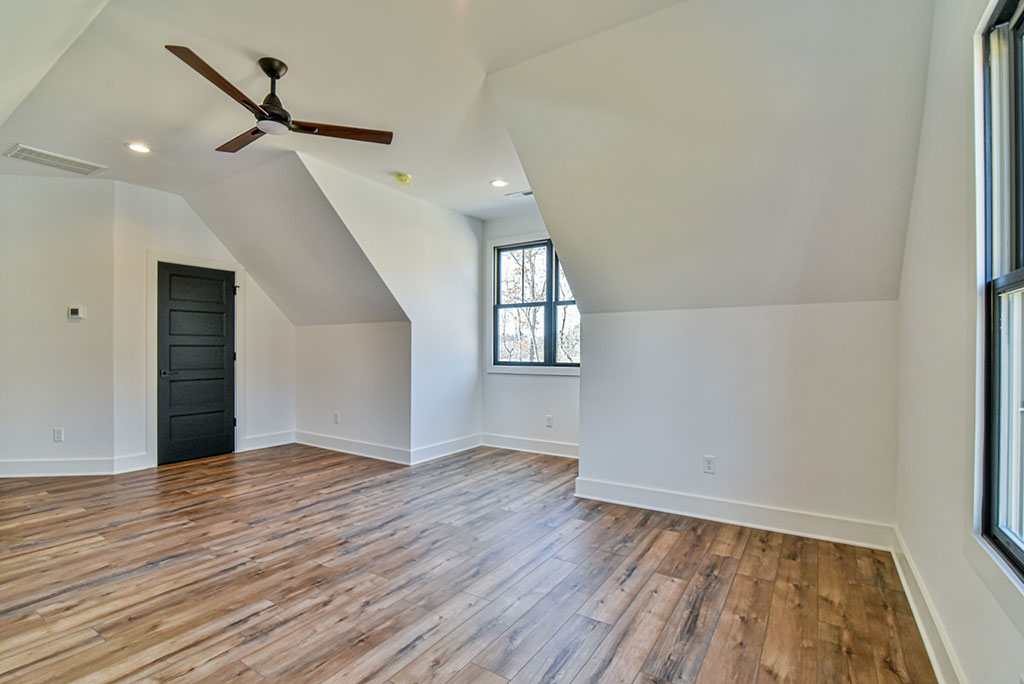Bonus room with a sloped ceiling, ceiling fan and wood-look flooring